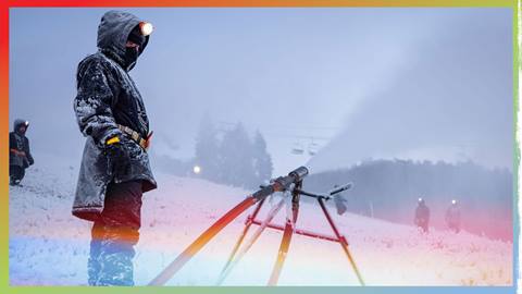 BBMR team member checking snowguns blowing snow onto ski hill.