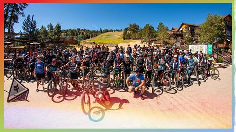 A large group of mountain bikers in the base area of Snow Summit