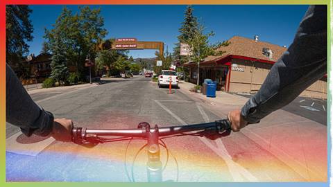 Adult riding a bike through The Village of Big Bear Lake