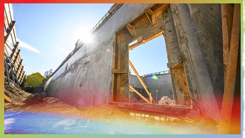 Wooden structural walls being plastered with concrete.