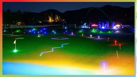 Bear Mountain Golf Course's driving range and putting area illuminated at night with different colored lit up lights to enhance a glow range experience.