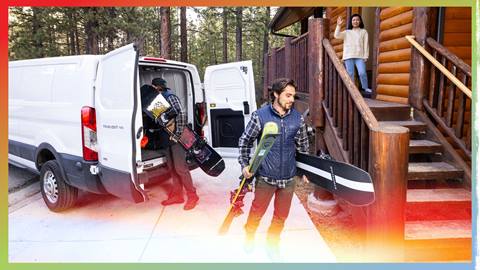 Two workers unloading ski and snowboard equipment for rental delivery to a customers cabin in Big Bear Lake during a calm bright winter day.