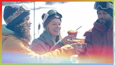 three snowboarders cheersing their bloody mary