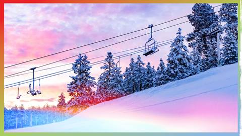 A morning sunrise over a chairlift after a fresh snowfall.