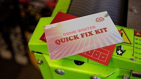 BBMR Winter Quick Fix Kit wax card lying on top of a snowboard and machine