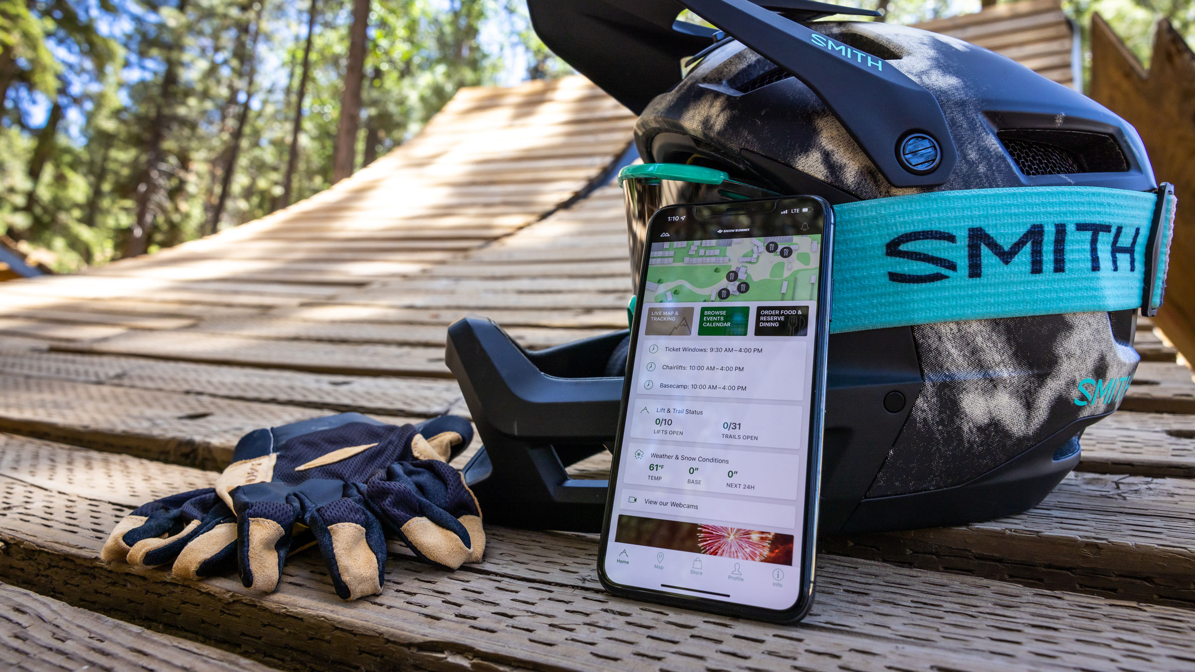 BBMR mobile app on an iphone leaning on a MTB helmet with smith goggles and gloves