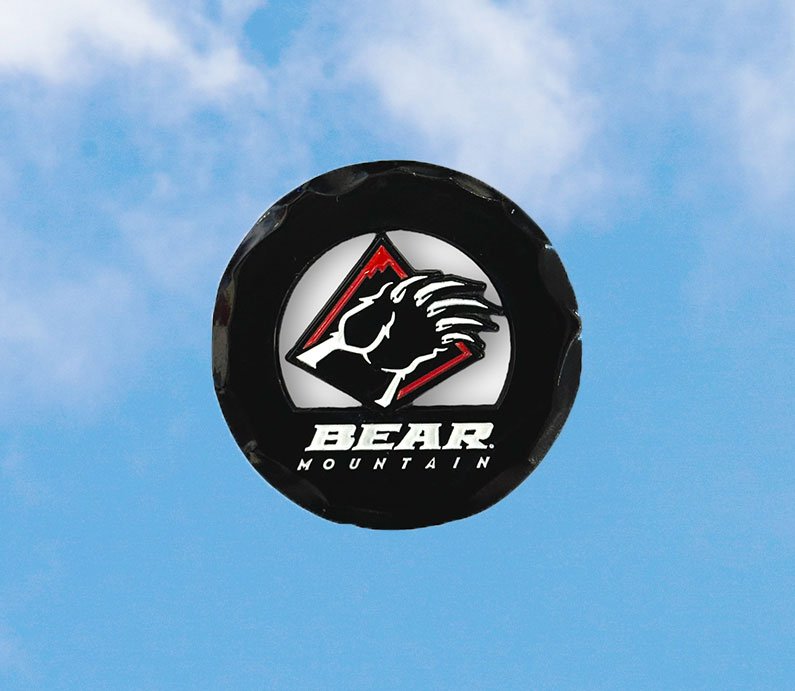 Black circular golf ball marker with the Bear Mountain bear claw logo in red and white.
