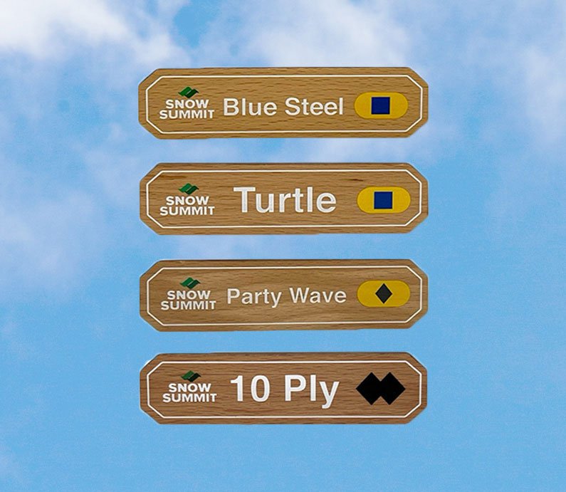 Wooden magnets with a Snow Summit logo on the left and trail signs for: Blue Steel, Turtle, Party Wave, and 10 Ply copy on it with difficulty legend rating.