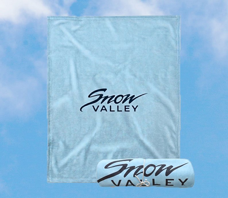 Light arctic blue blanket with Snow Valley logo in dark font.