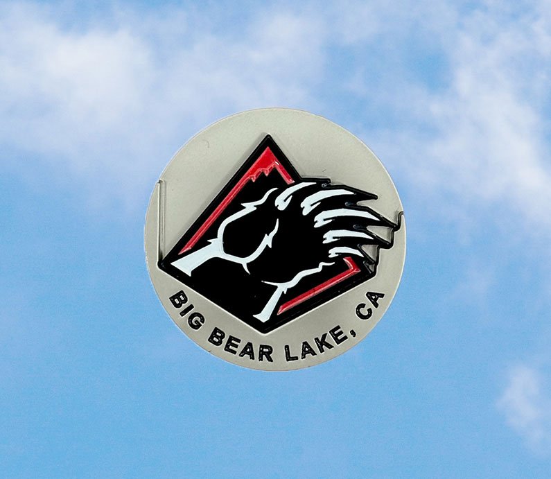 Silver golf ball market with Big Bear Lake, CA words at the bottom and a bear blaw removable ball marker in black, red, and white.