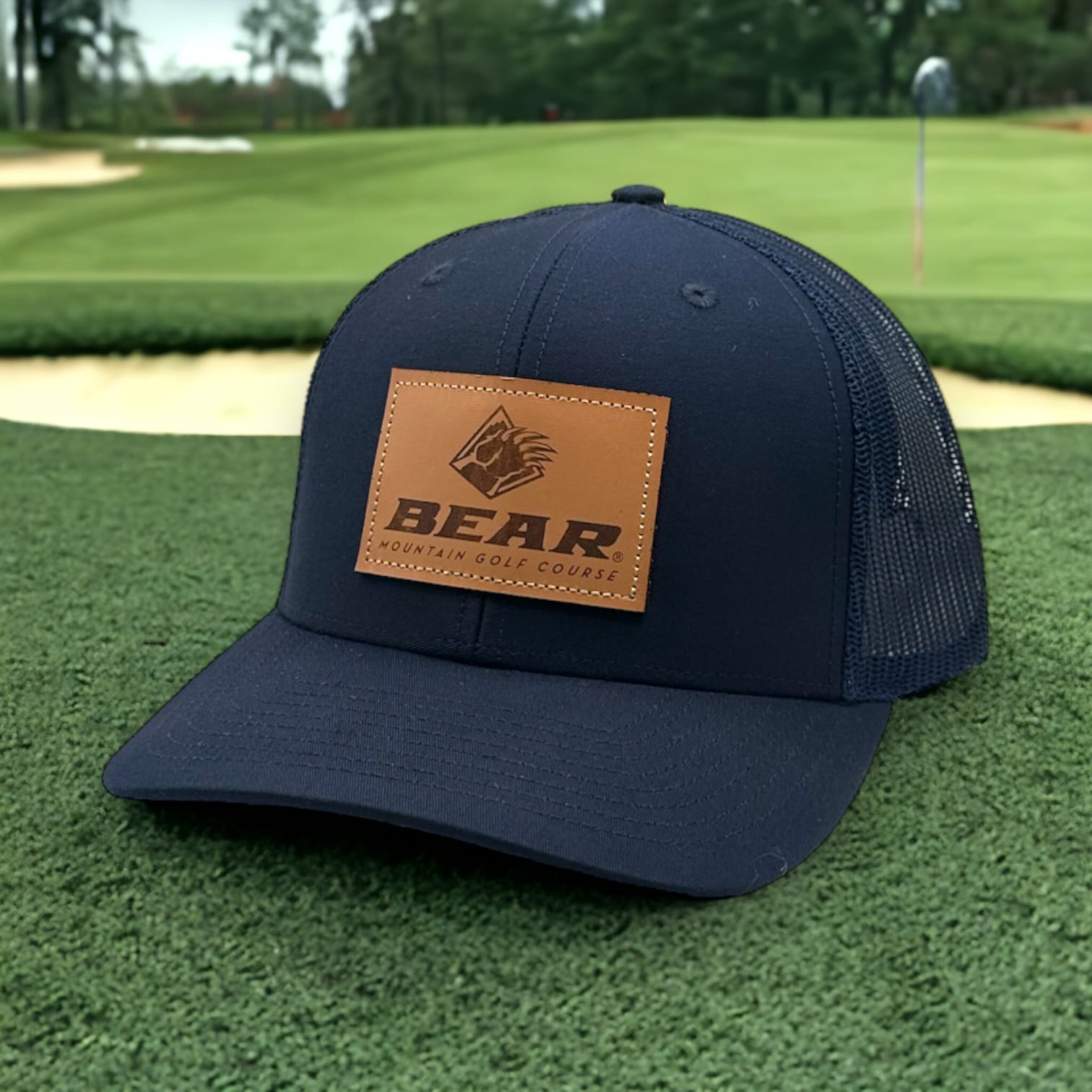 Blue trucker had with bear mountain logo on a leather patch on the front