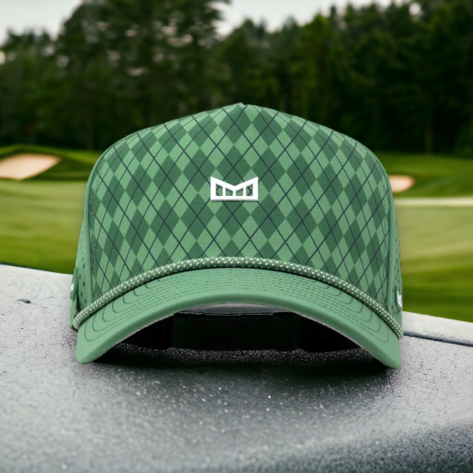 Melin golf hat in argyle green pattern with a golf tee holder on the side of the hat 