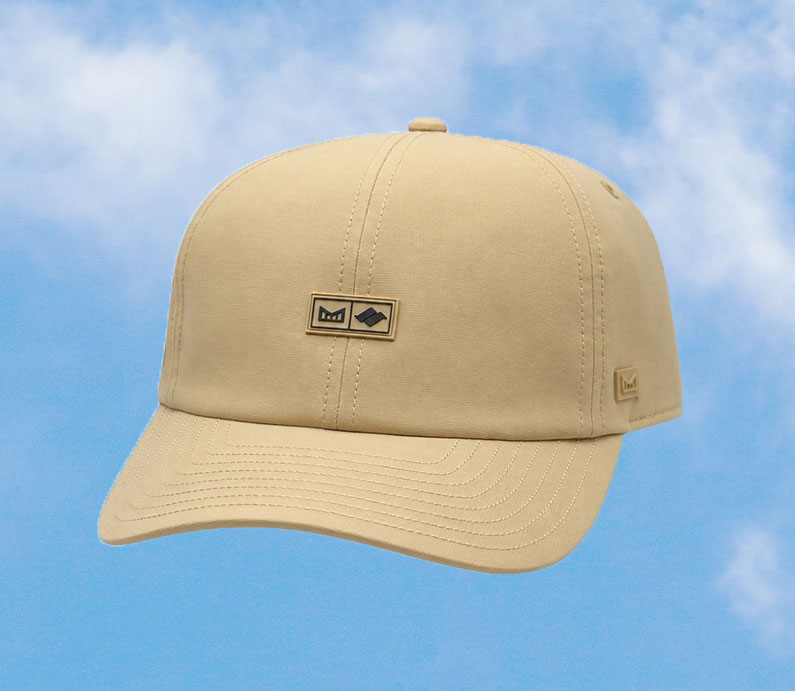 The frontside of a khaki color Melin strap hat with Snow Summit logo on front.