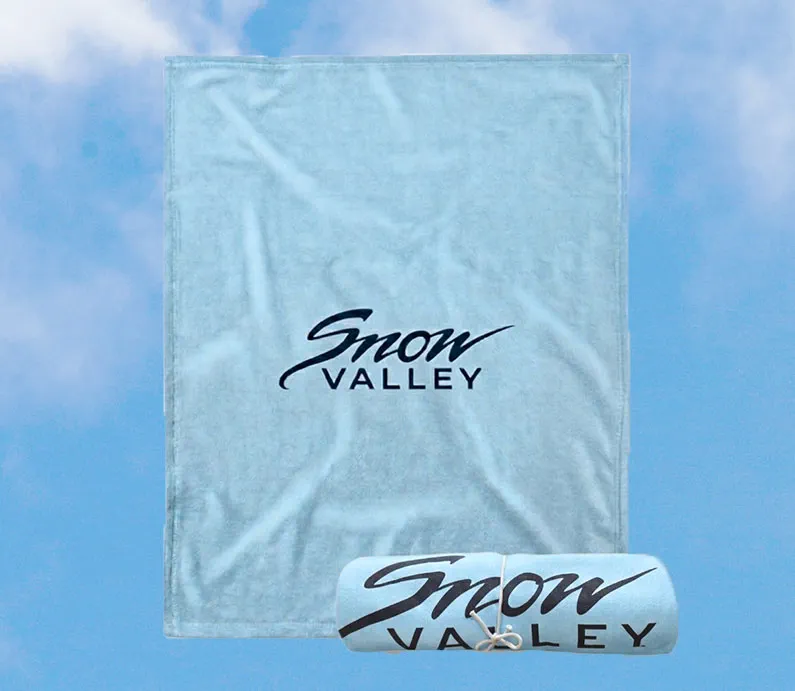 Light arctic blue blanket with Snow Valley logo in dark font.