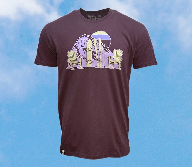 Plum colored t shirt with purple gradient sun and mountain design with a snowboard, skis, and two chairs in light cream color.