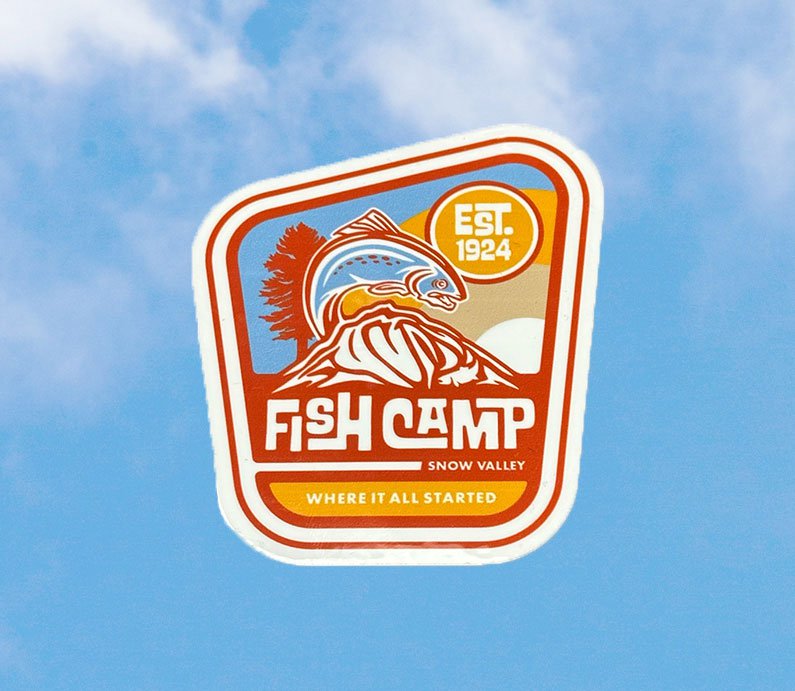 Snow Valley Fish Camp where it all started sticker with a tree and fish design in orang, red, blue, and white.