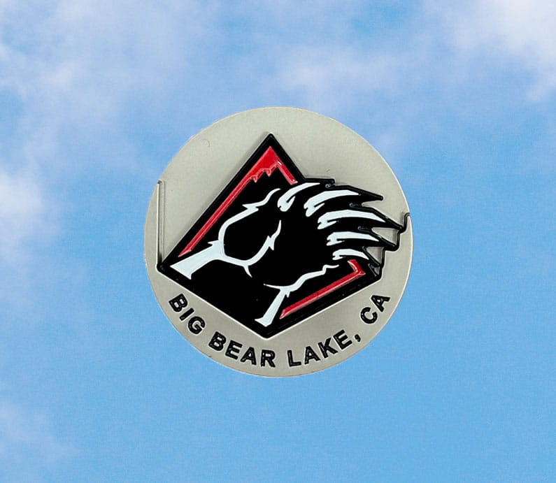 Big Bear Lake, CA words on a silver metal golf ball market with the Bear Mountain bear claw logo in red, white, and black.