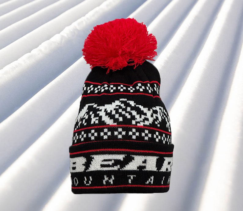 Black Beanie with white bear mountain stitching for the logo and red accent stitching with red pom pom at top