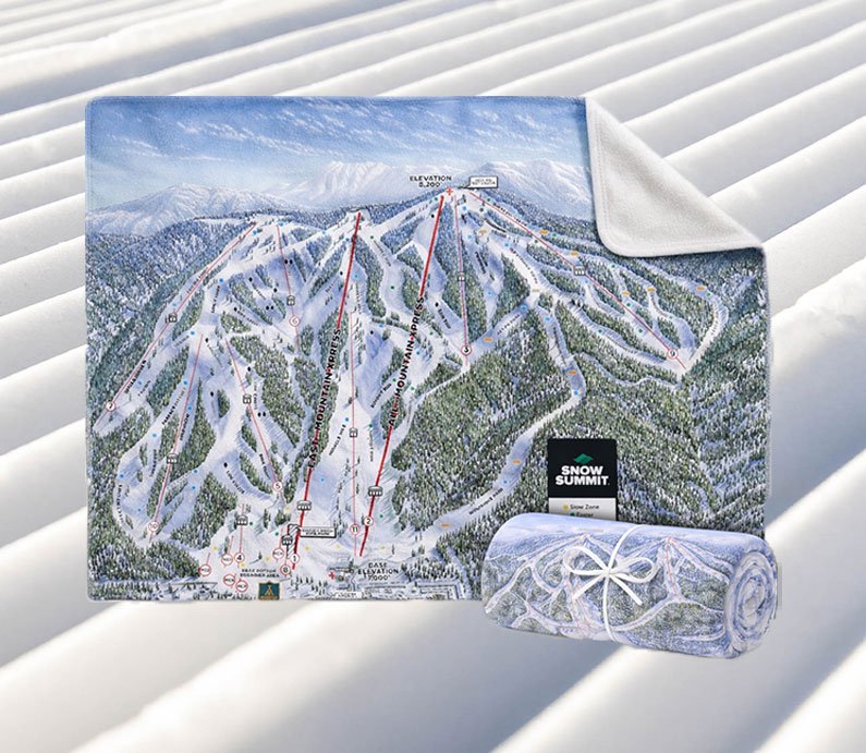 A blanket with Snow Summit's winter trail map on one side, with an opposing blank white side.