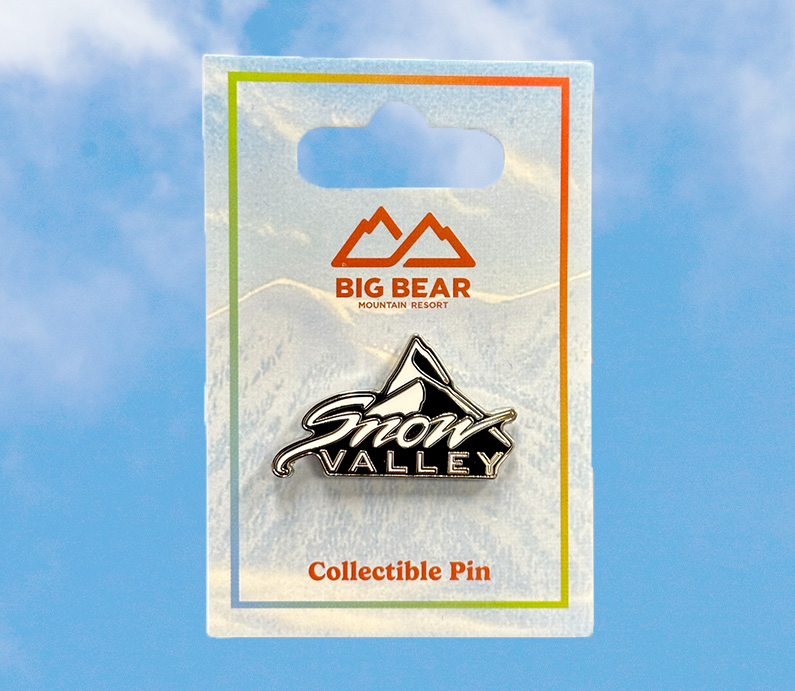 collectible snow valley logo pin in black and white with a colorful big bear mountain resort package.