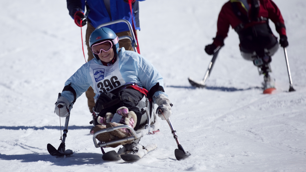 USARC program with our adaptive skier and their guide with another adaptive skier behind them