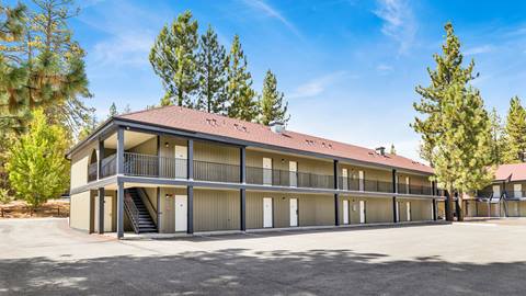 An outside view of one of the employee housing two story dark color buildings from the parking lot.