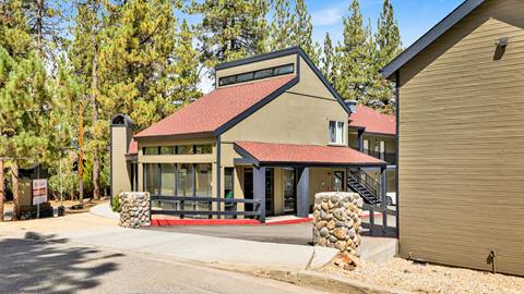 Entrance to the employee housing parking lot with two small rock pillars on each side of the entry way.