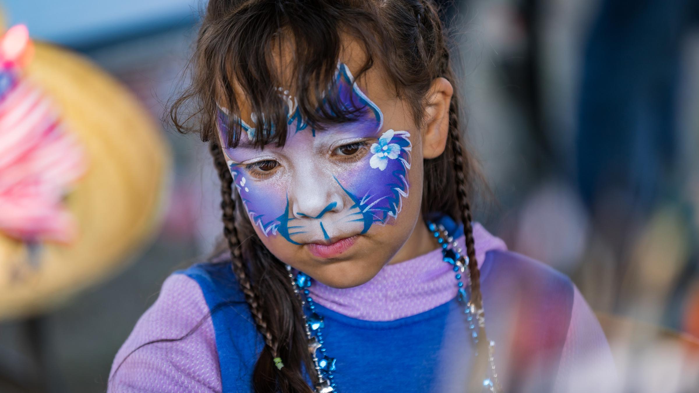 Young girl with purple face paint