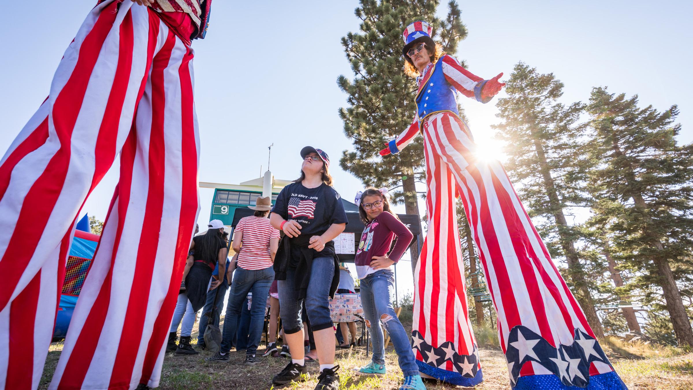 Stilt walker wearing red, white, and blue