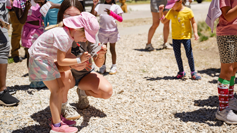 Children and families participating in outdoor summer activities and games at Biggie's Adventure Outpost at Big Bear Mountain Resort.