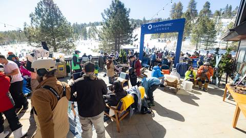 Crowd of adults at the base of Snow Summit enjoying the Chase Sapphire Lounge.