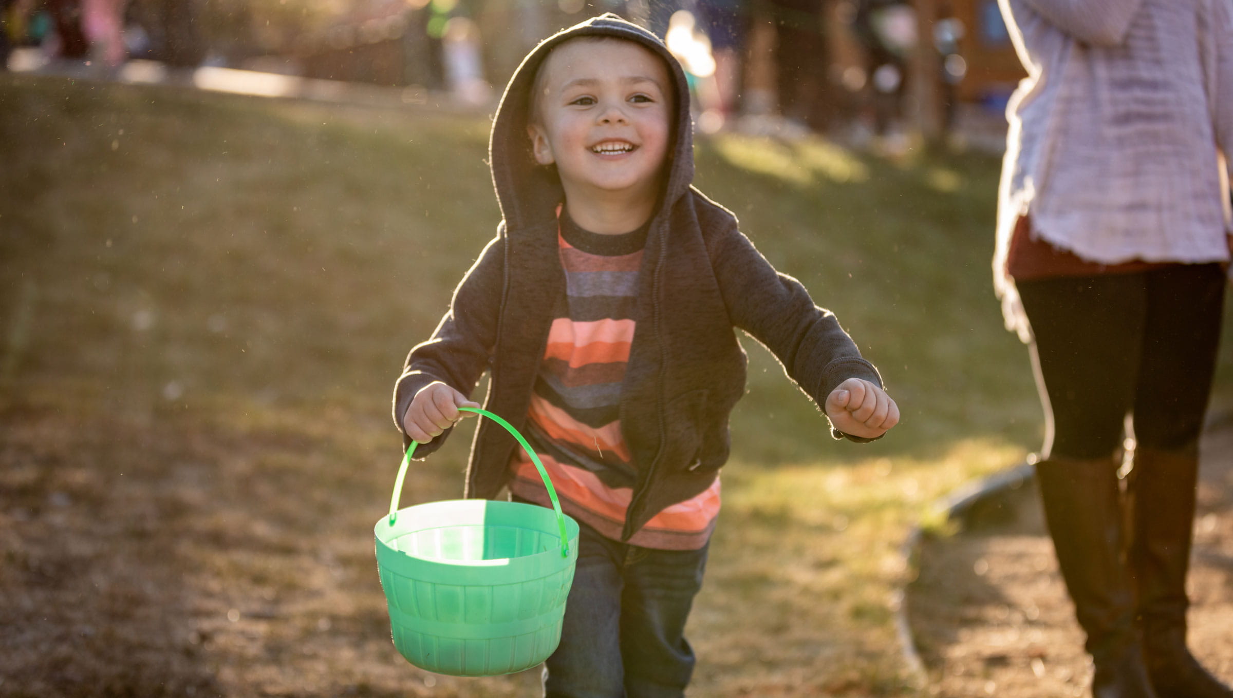 Little boy running, holding an easter basket