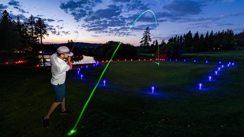 Guy hitting glow golf ball