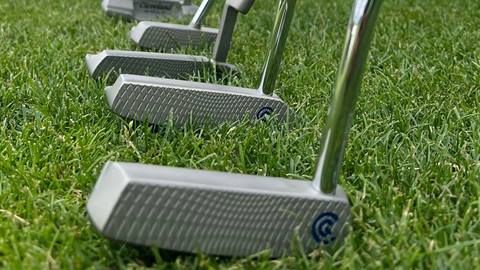silver golf clubs on the grass