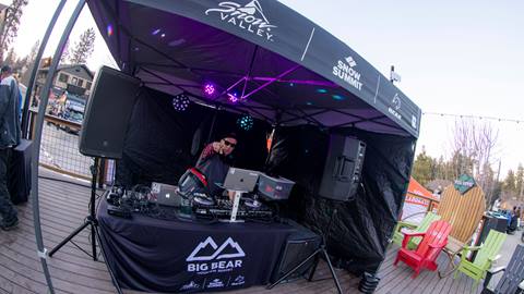 DJ Slipmatt spinning under a Big Bear Mountain Resort branded ez up tent in the base area of Snow Summit.