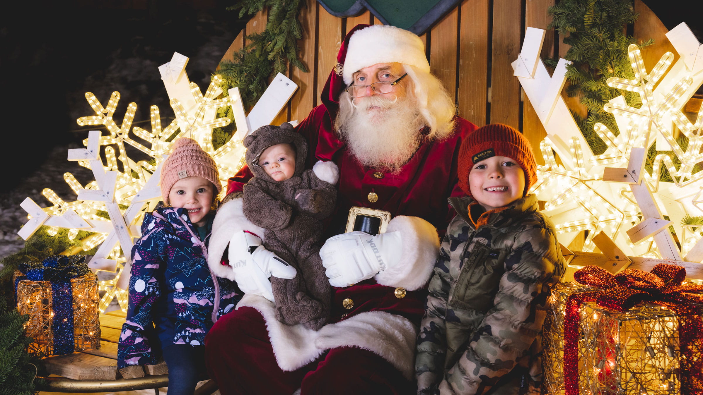 Santa taking a photo with 3 kids