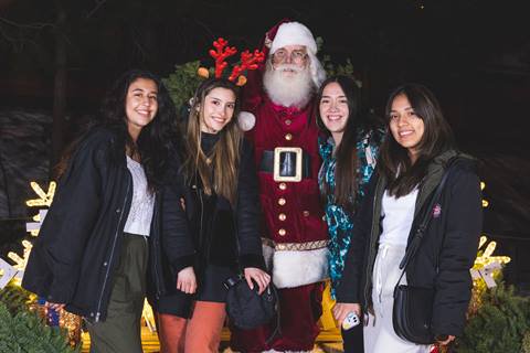 Santa taking a photo with 4 female adults