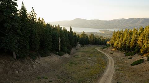 Big Bear Lake view from a chairlift ride at Snow Summit during summer haze sunset.