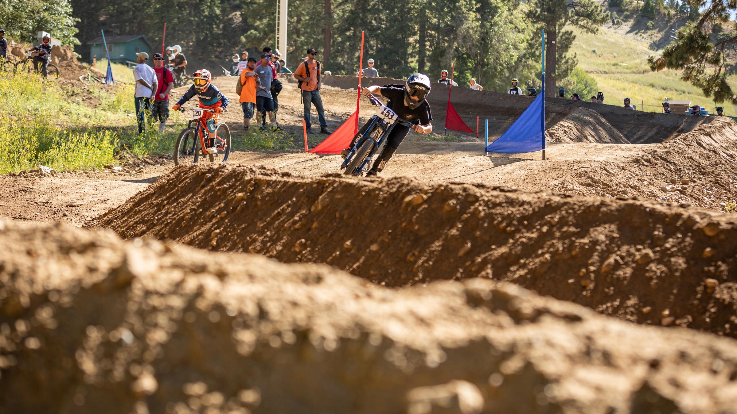 Dual slalom race two mountain bikers