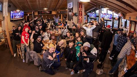 A large group of adults and children at the Super Sunday Viewing Party at Bear Mountain's Methods Sports Bar & Coffee venue.