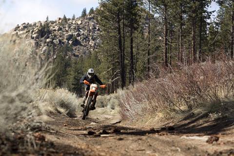 Motorcycle rider riding in mud