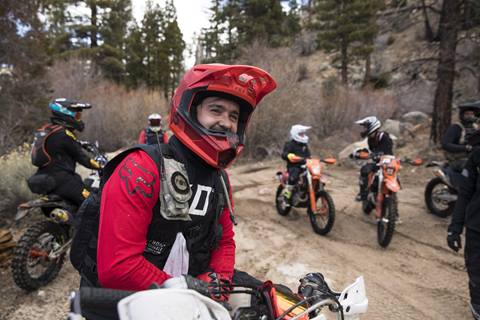 Group of motorcycles in the wilderness, smiling at the camera