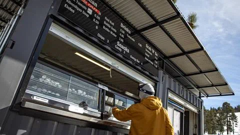 Guy ordering food at a container stand
