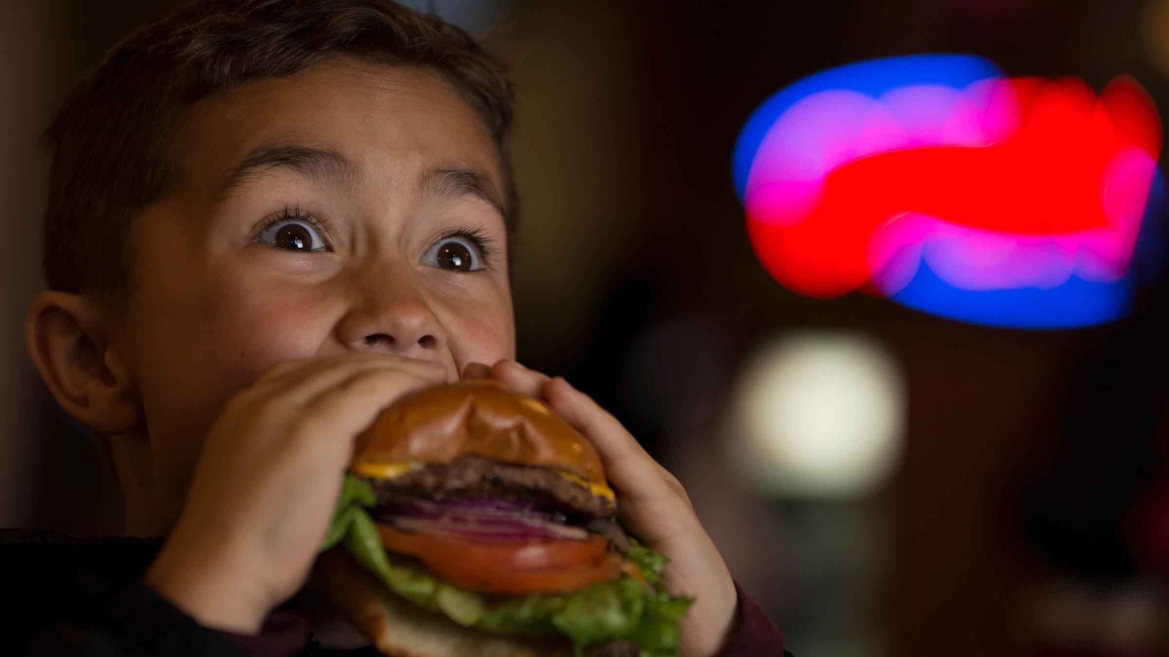 Child eating a cheeseburger
