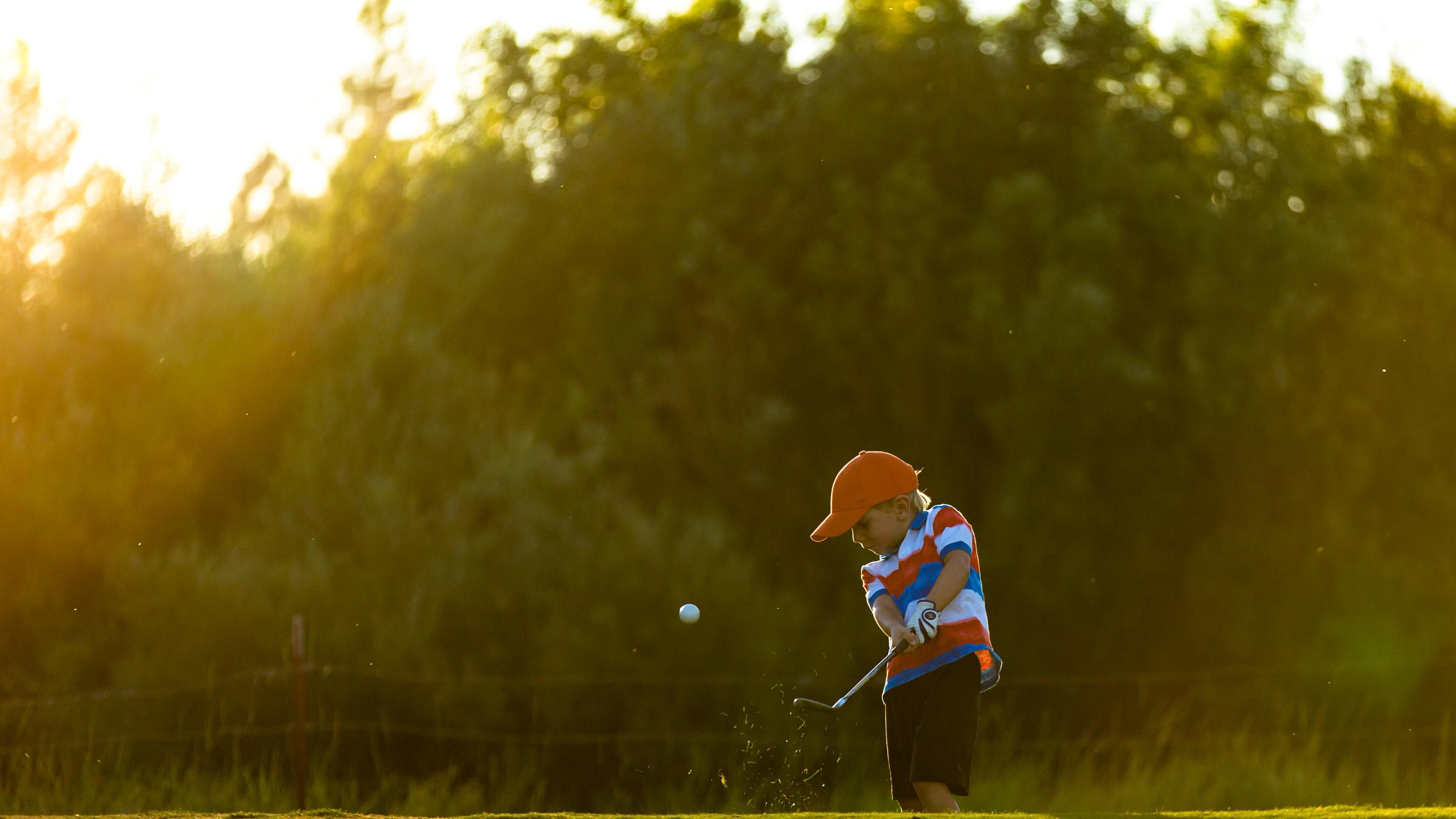 Young child playing golf