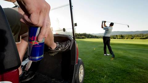 Golfer next to golf cart