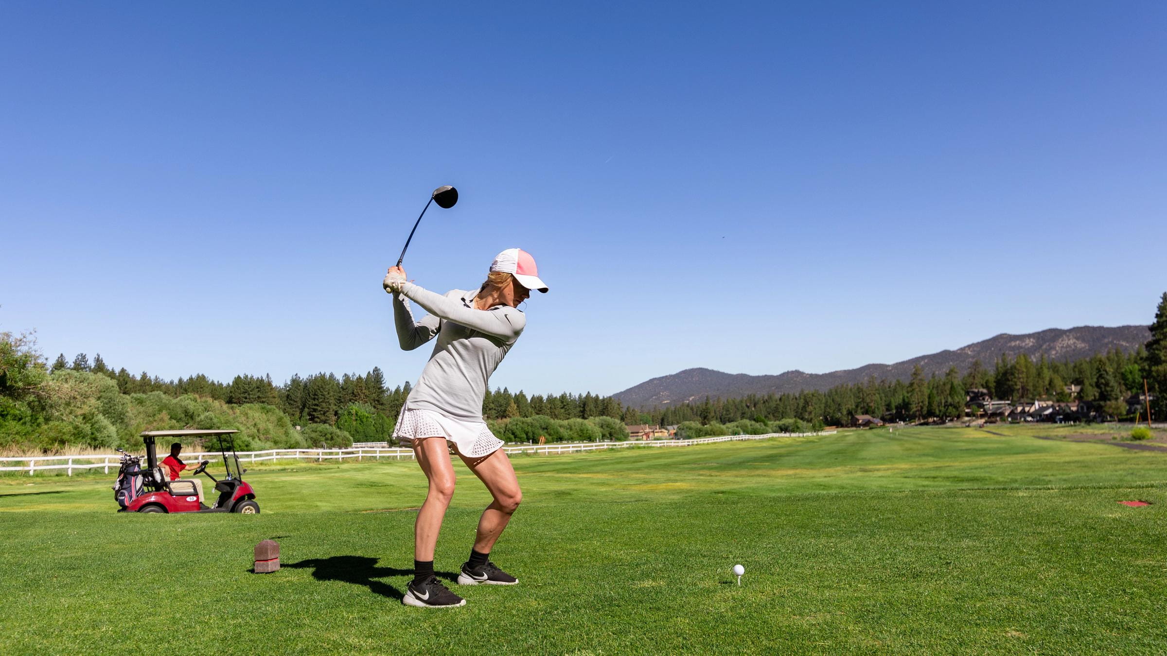 Female golfer hitting golf balls