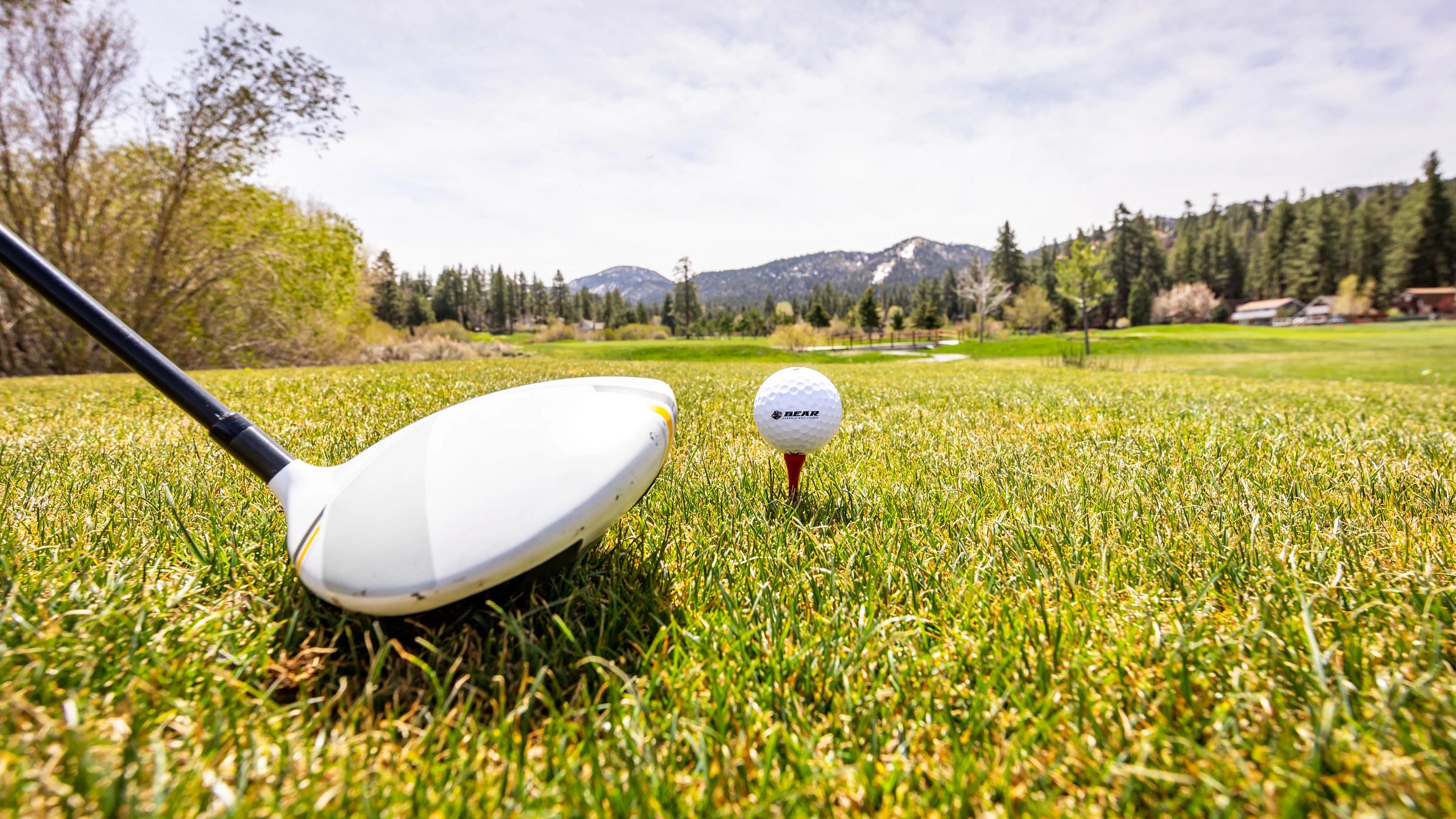 Close up of club ready to hit a golf ball