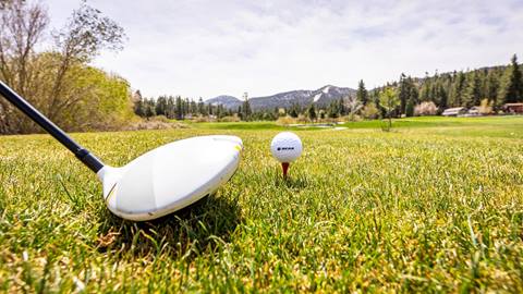 Close up of club ready to hit a golf ball