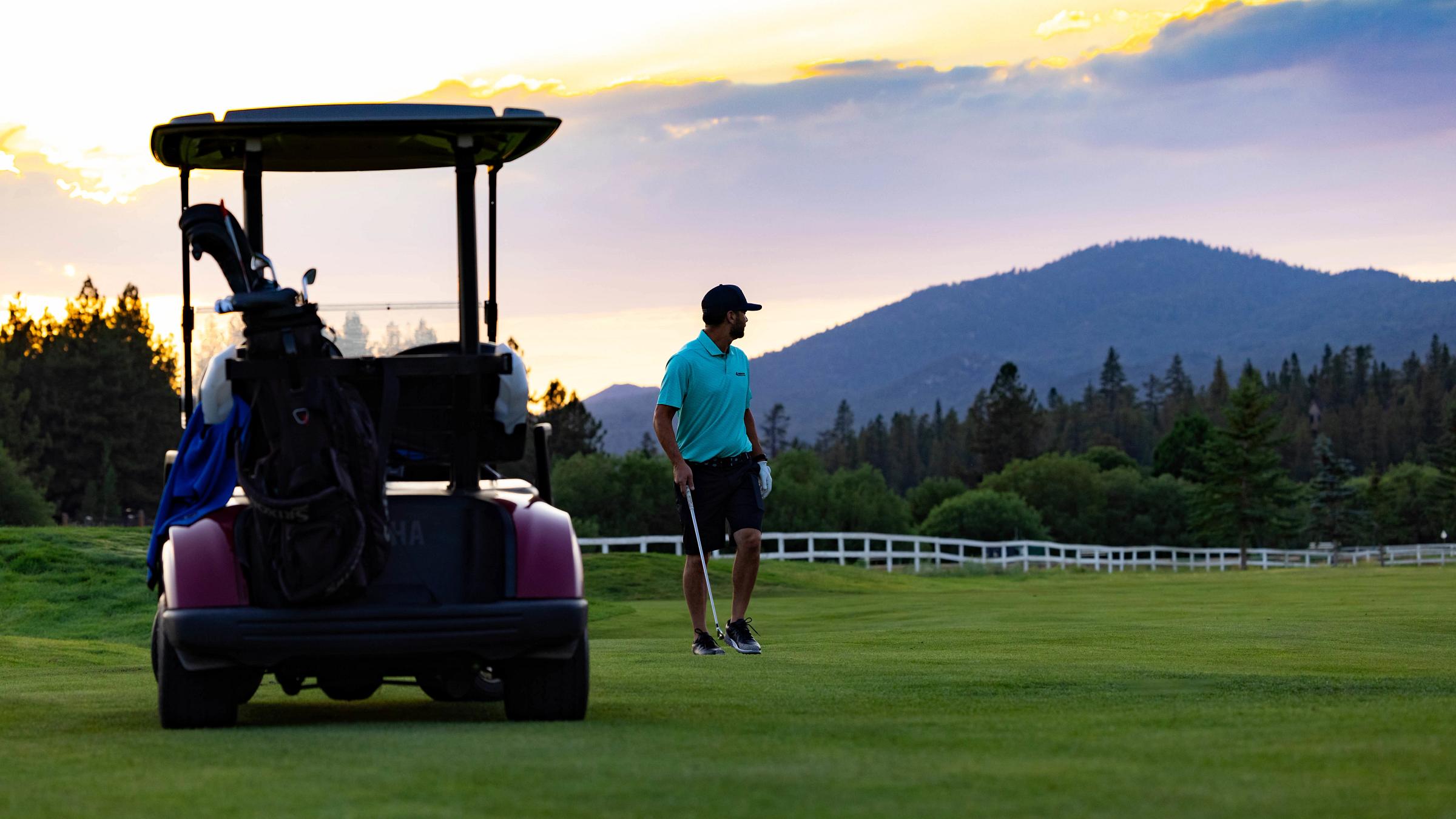Golfer next to golf cart